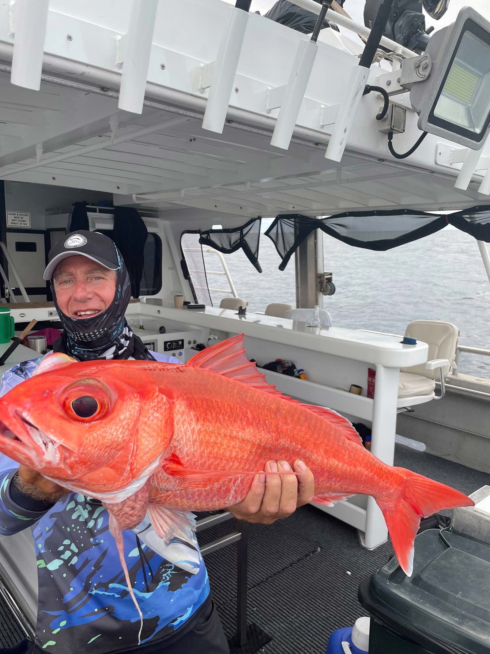 Brian Edwards holding his ruby snapper caught off the coast of Australia