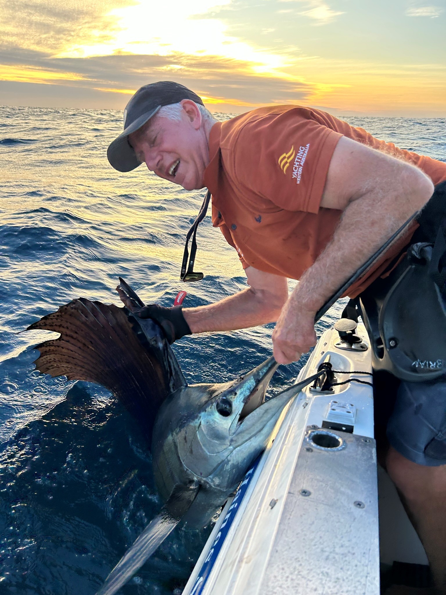 Brian Edwards bringing large marlin to the boat after catching this trophy