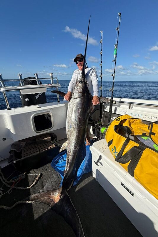 Huge Swordfish being held up by fisherman off the coast of Perth, Western Australia